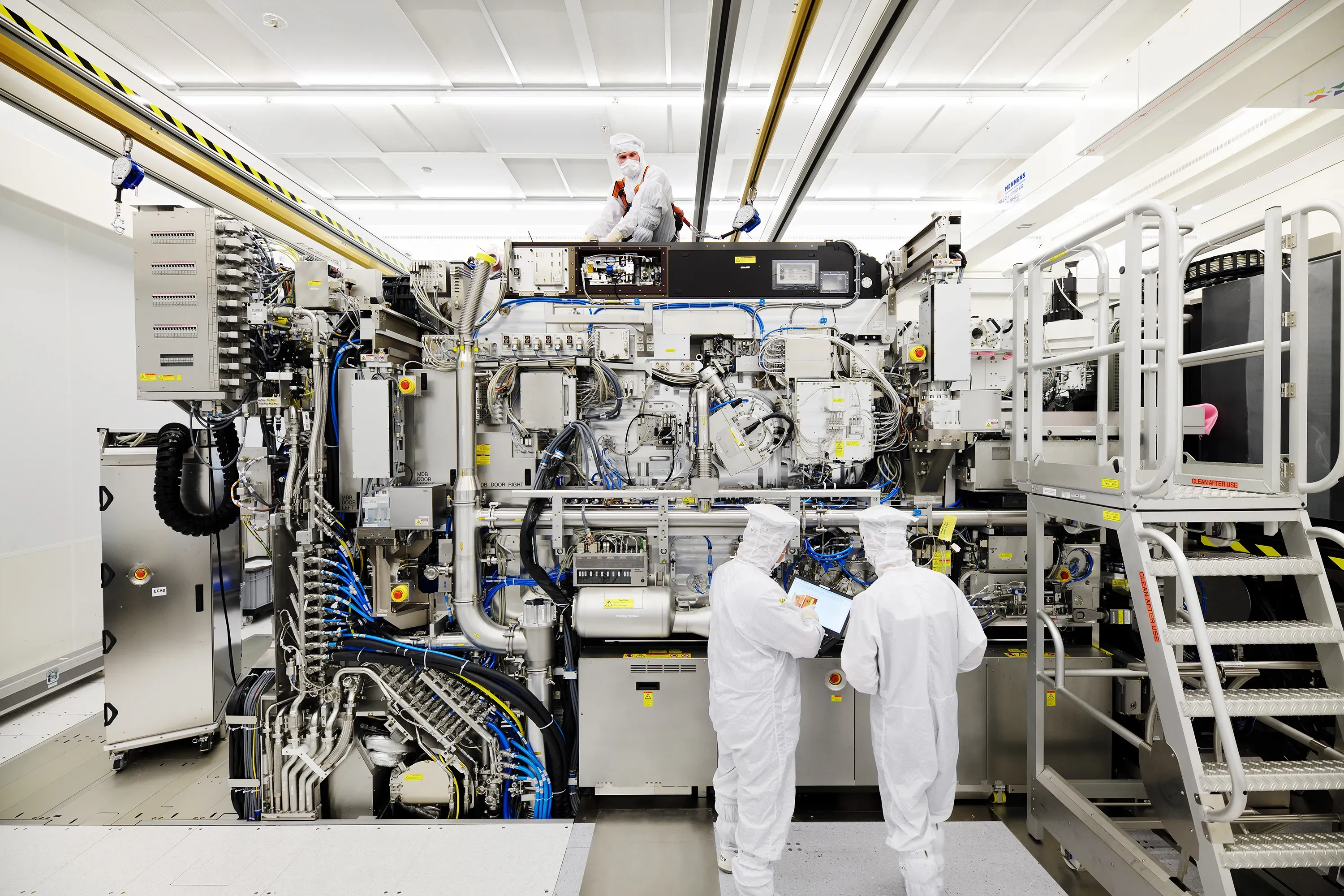 Process technicians reviewing tool data at a lithography system during final assembly